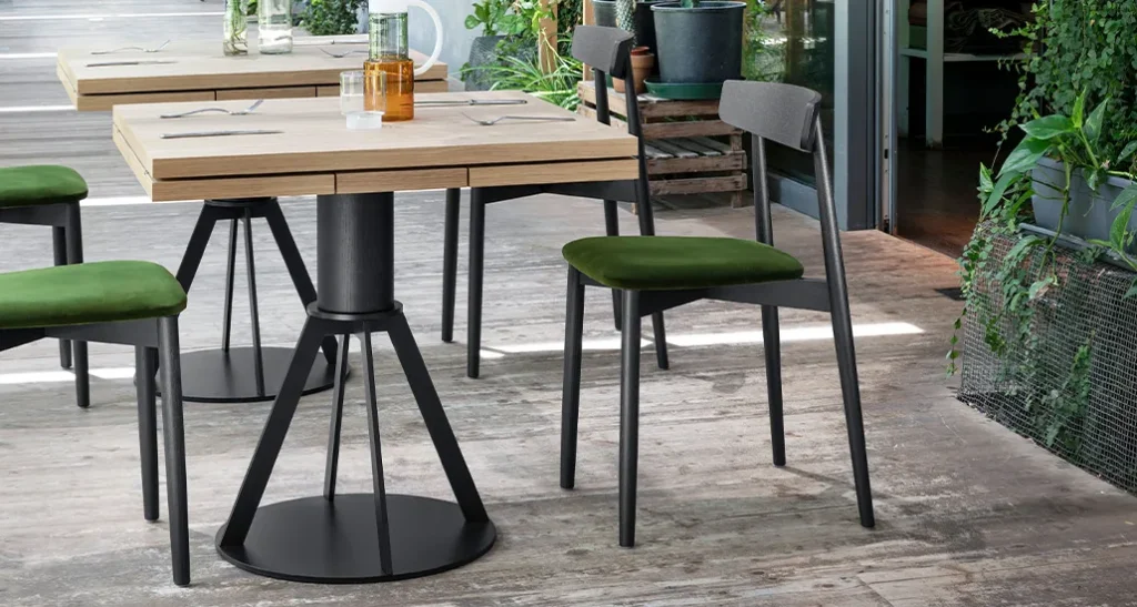 Geronimo table is a contemporary minimalist dining table with oak and walnut finishes suitable for hospitality and contract spaces