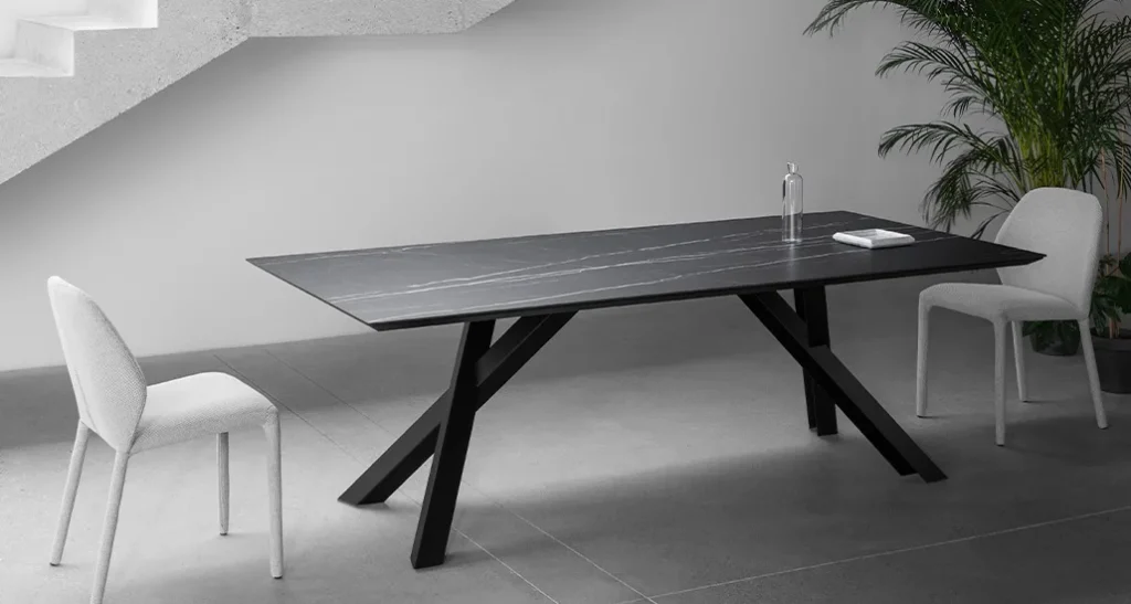 Gustave dining table is a contemporary dining table with ceramic top and wood base suitable for hospitality and contract settings