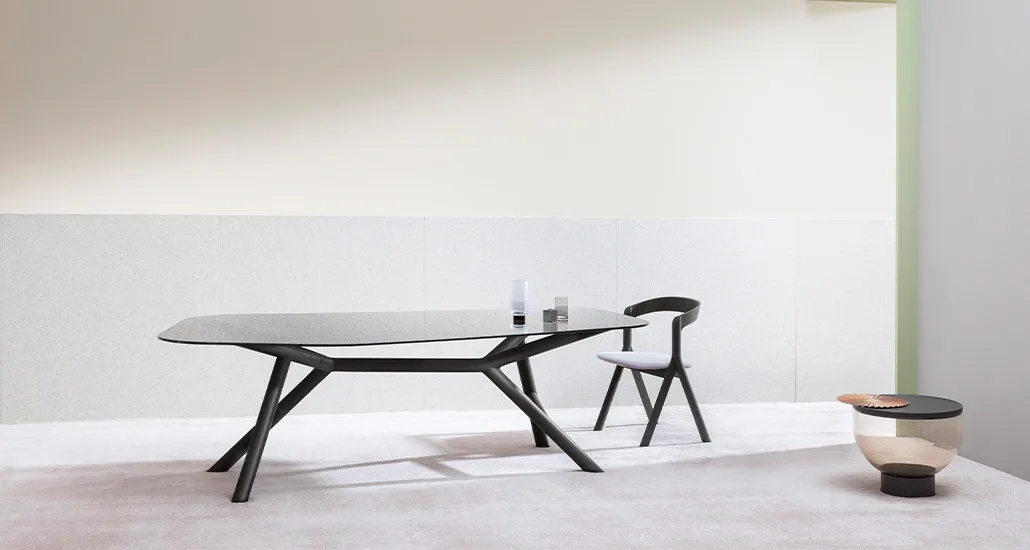 Otto Table is a contemporary dining table with glass top and walnut leg finish, and is suitable for contract and hospitality requirements..