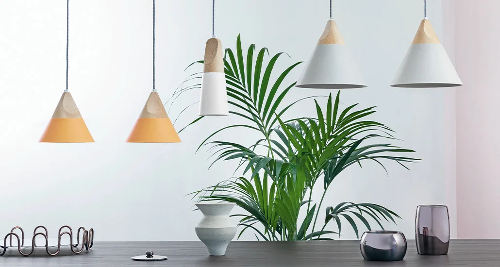 Slope is a contemporary pendant light with wood and metal body suitable for hospitality, residential and contract spaces