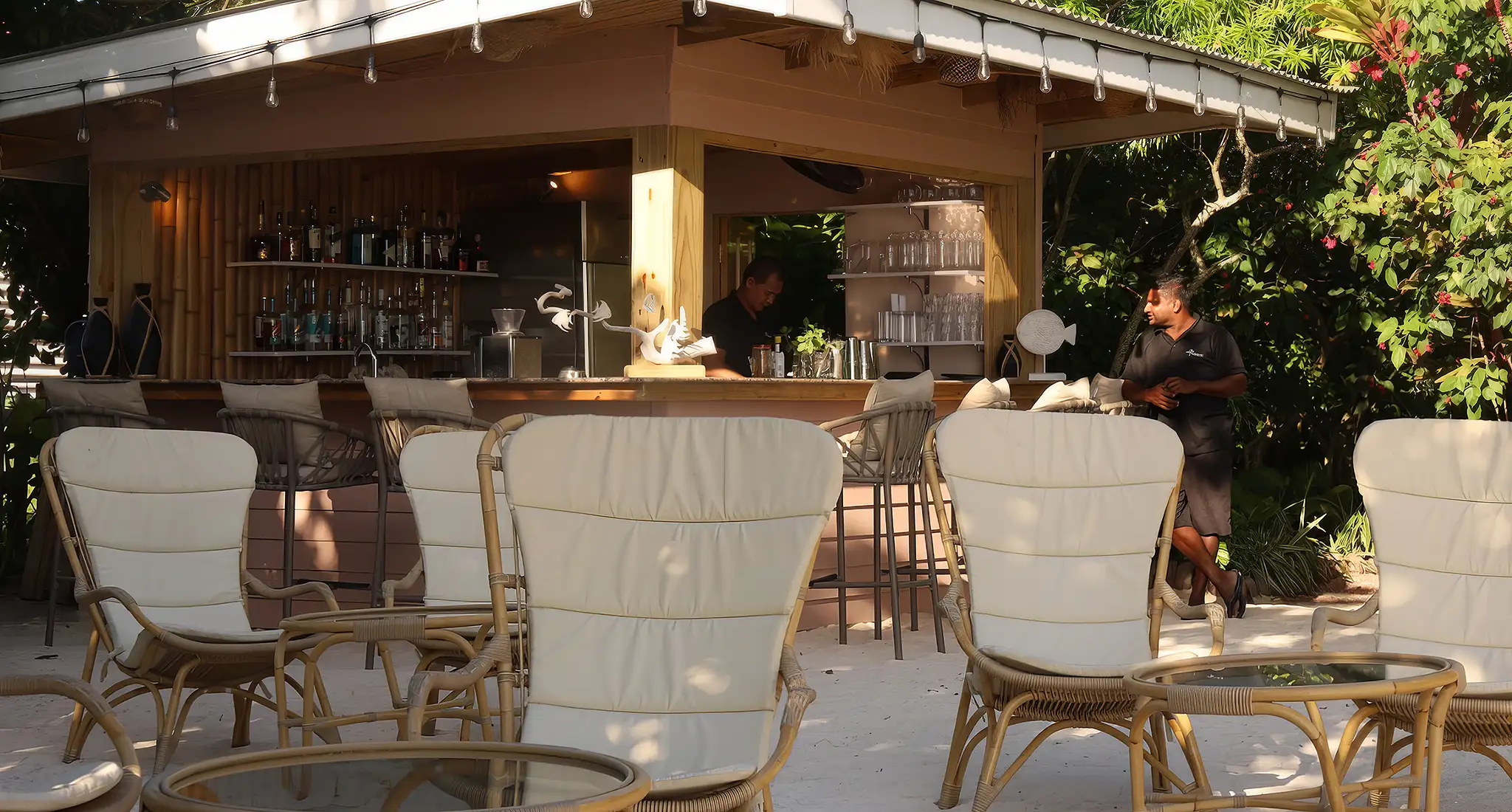 a picturesque bar with chairs and tables arranged outside, provided by le repaire boutique hotel and restaurant in victoria, seychelles.