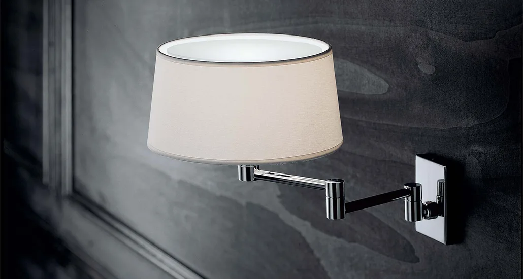 Classic wall lamp is a contemporary wall lamp with fabric lampshade and brass holder and is suitable for hospitalitym contract and residential projects