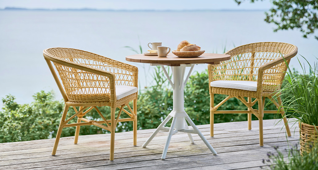 emma exterior chair is a contemporary outdoor dining chair made of wicker suitable for hospitality exterior seating