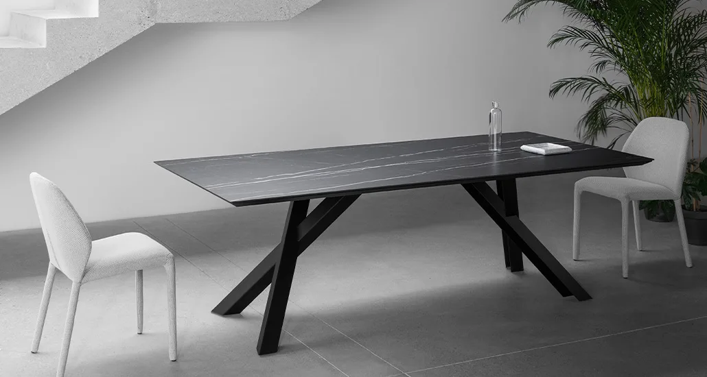 Gustave dining table is a contemporary dining table with ceramic top and wood base suitable for hospitality and contract settings