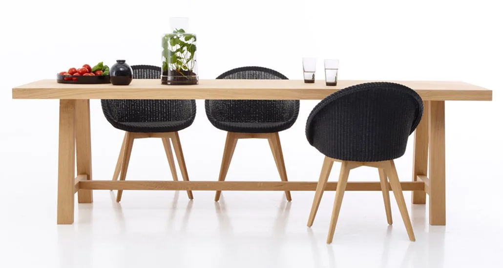 Dan Dining Table with Joe Dining chairs wood base by Vincent Sheppard are Scandinavian model dining table and chair that exudes a warm comfort and calmness to surroundings. Joe Dining Chair is made of Lloyd Loom and the chair is a modern interpretation of tradition and style.