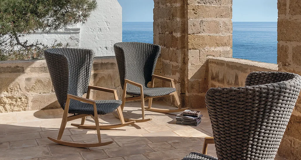 knit rocking chair is a contemporary outdoor chair with rope seat and teak armrest and base. the knit rocking armchair is best suitable for contract and hospitality projects.