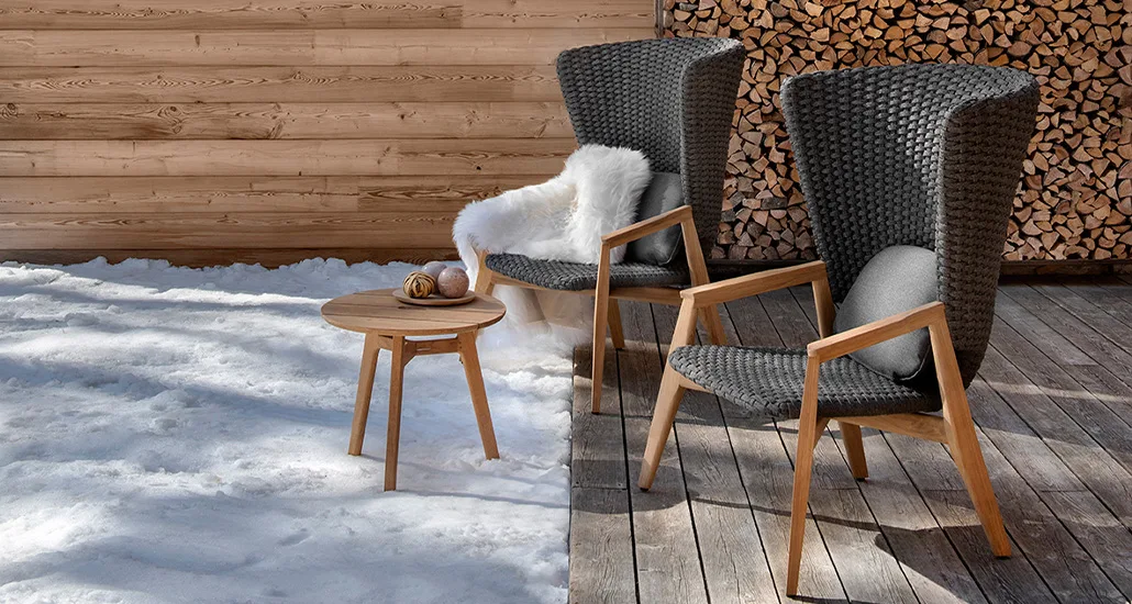 Knit high back armchair is a contemporary outdoor armchair with weaved rope backrest and teak base suitable for hospitality spaces
