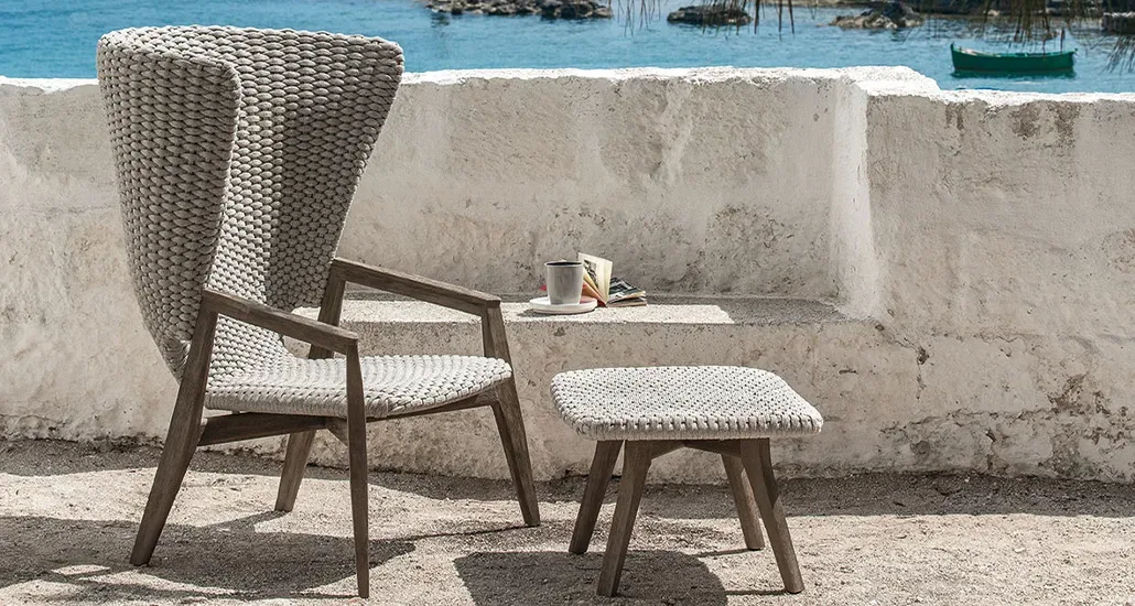 knit high back armchair is a contemporary outdoor armchair with weaved rope backrest and teak base suitable for hospitality spaces