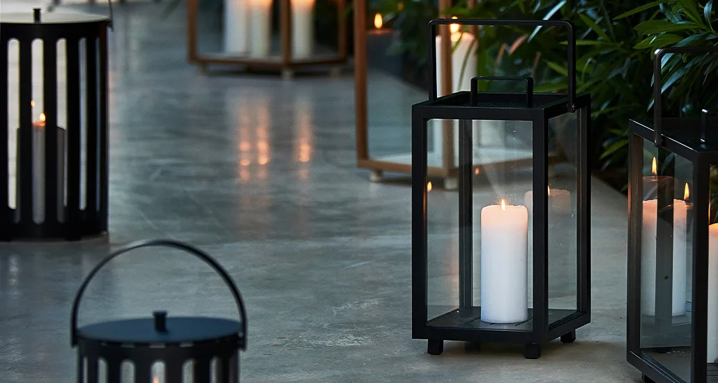 lighthouse lantern is a contemporary outdoor candle lantern with teak and aluminium structure and is suitable for hospitality and contract projects