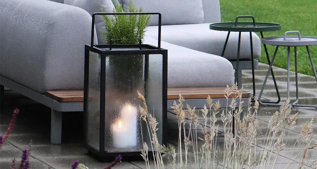 lighthouse lantern is a contemporary outdoor candle lantern with teak and aluminium structure and is suitable for hospitality and contract projects