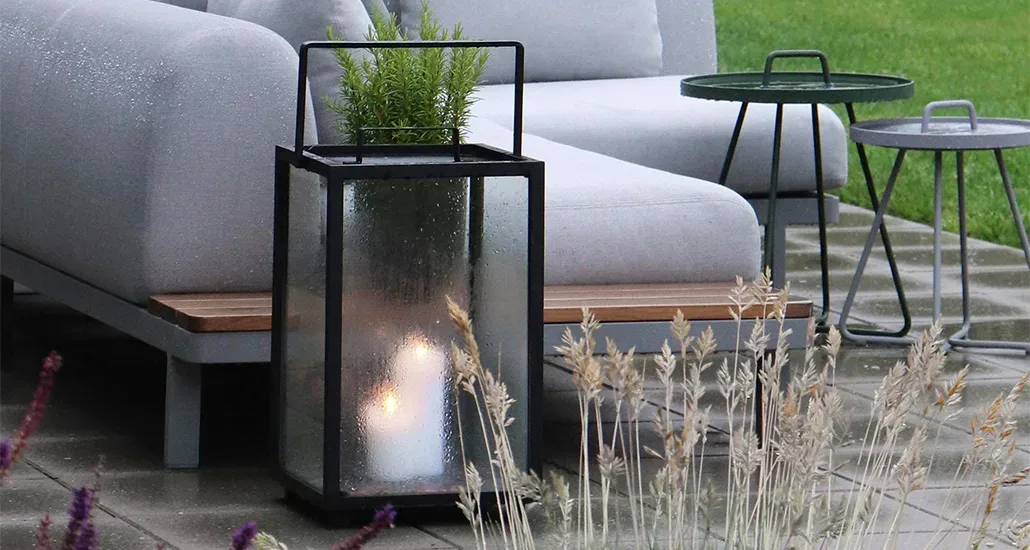 Lighthouse lantern is a contemporary outdoor candle lantern with teak and aluminium structure and is suitable for hospitality and contract projects