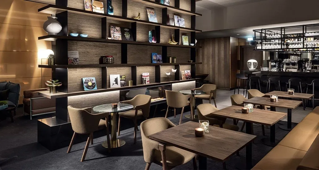Loden dining armchair defines contemporary seating in this restaurant with a wooden theme throughout