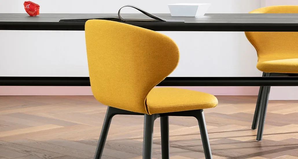 mula is a contemporary upholstery dining chair with polyurethane seat shell and wood base suitable for hospitality projects