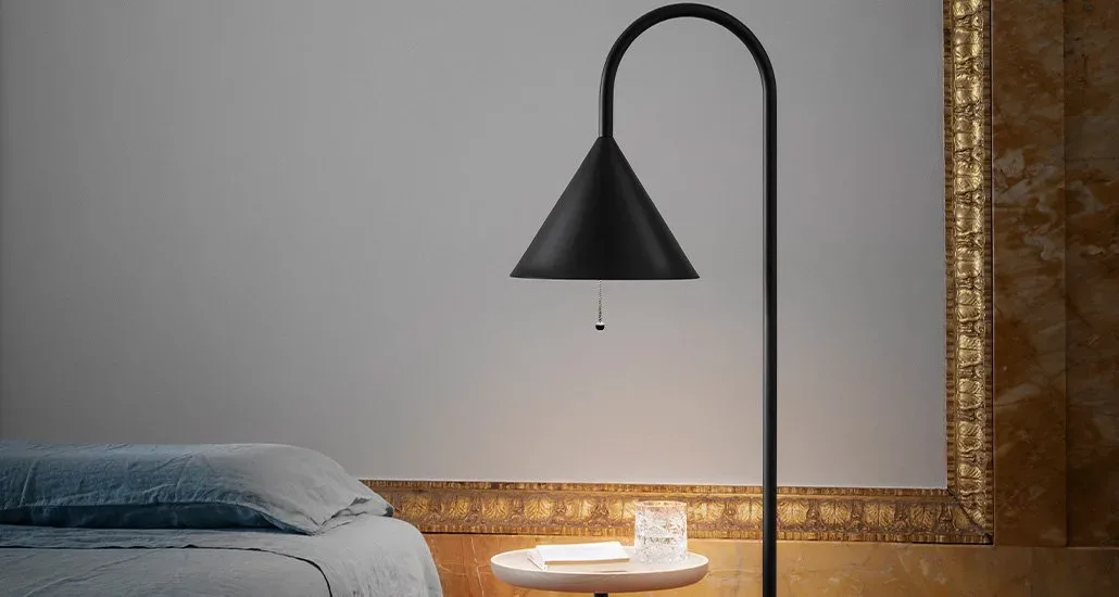 ozz floor lamp by miniforms beside bed