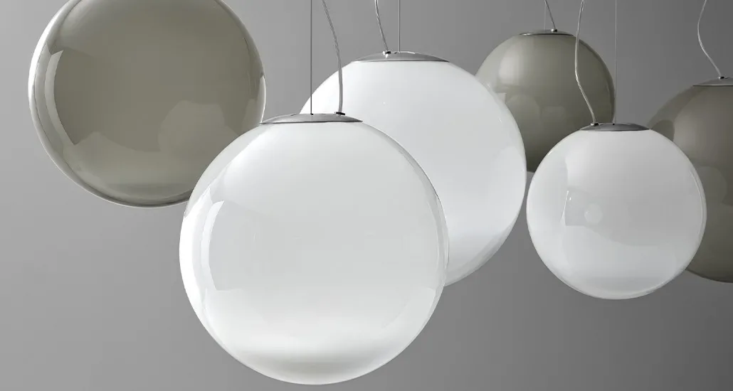 smoke suspension lamp by panzeri is dimmable led pendant lamp in sphere shape made of blown glass and is suitable for both hospitality and contract settings