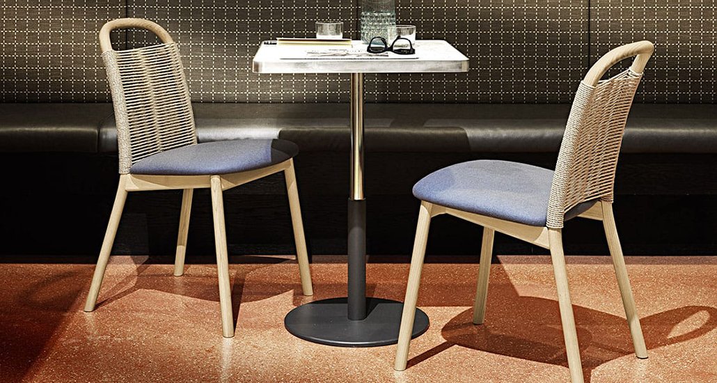zantilam 32 nr chairs placed in an restaurant with booth seating in background and marble table top cafe table