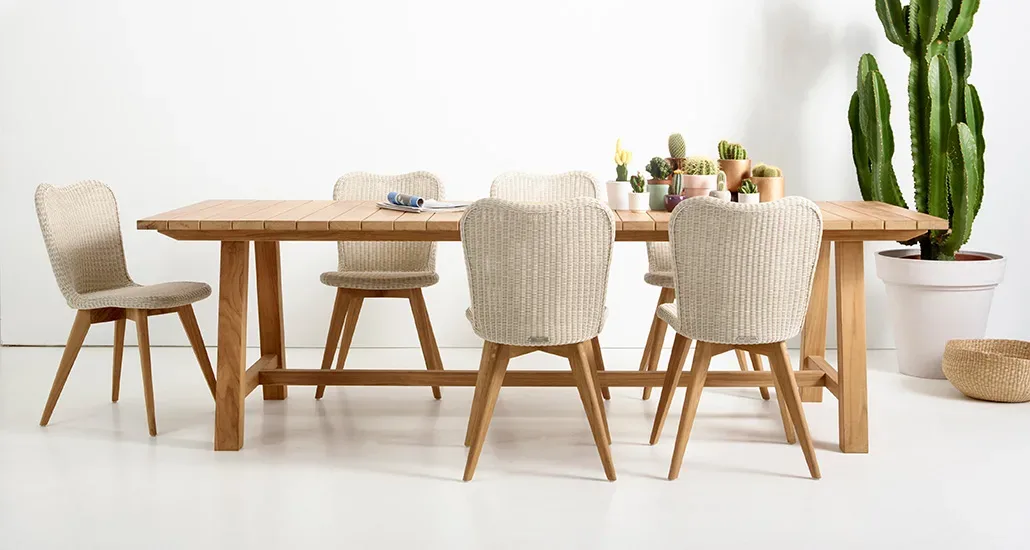 lena dining chair is a contemporary outdoor dining chair with wicker and steel seat and wood base is suitable for hospitality and contract projects.