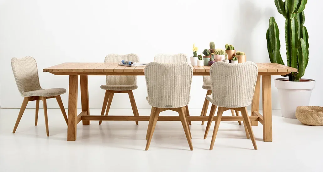 Lena dining chair is a contemporary outdoor dining chair with wicker and steel seat and wood base is suitable for hospitality and contract projects.