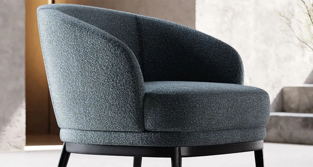 Ruth armchair is a contemporary upholstered armchair with ash base and leather or velvet fabric finish, suitable for hospitality and contract projects.