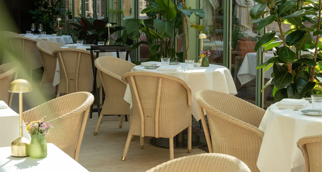 chester dining chair is a contemporary dining chair with weave finish and is suitable for contract and hospitality projects. here we see it in an outdoor restaurant setting.